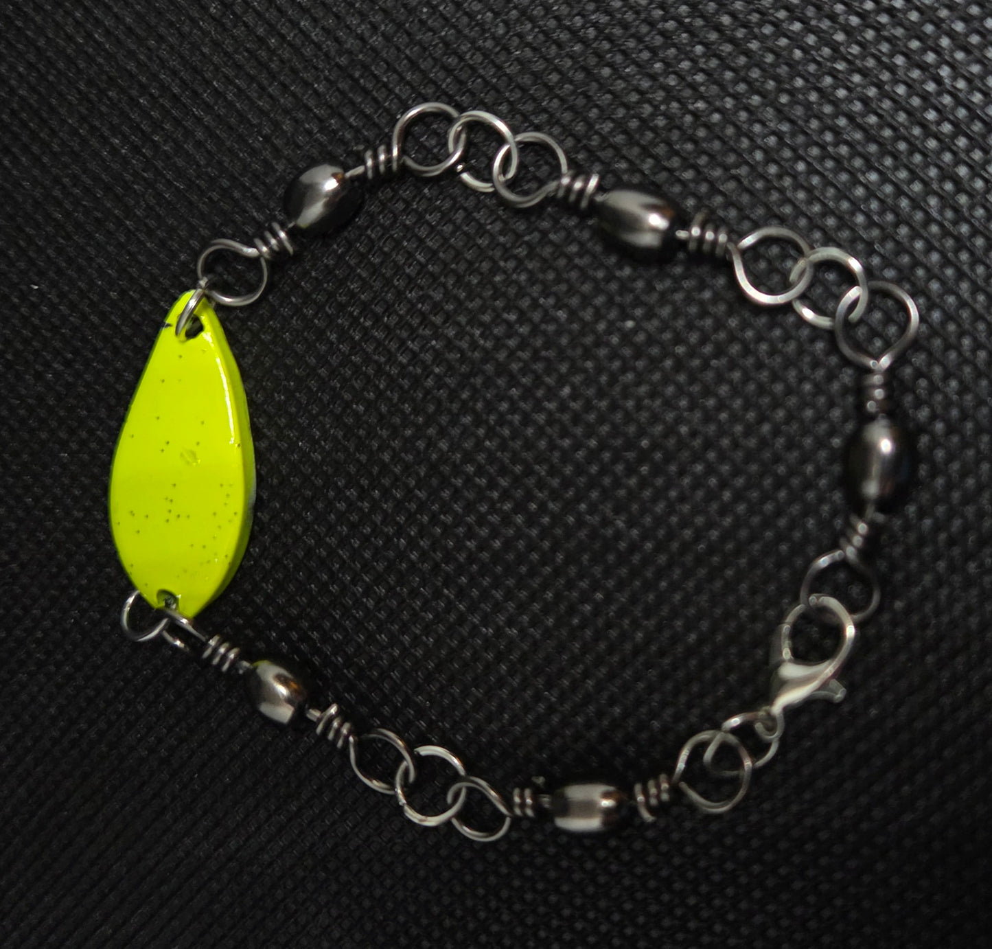 Fishing swivel bracelet with yellow spoon lure
