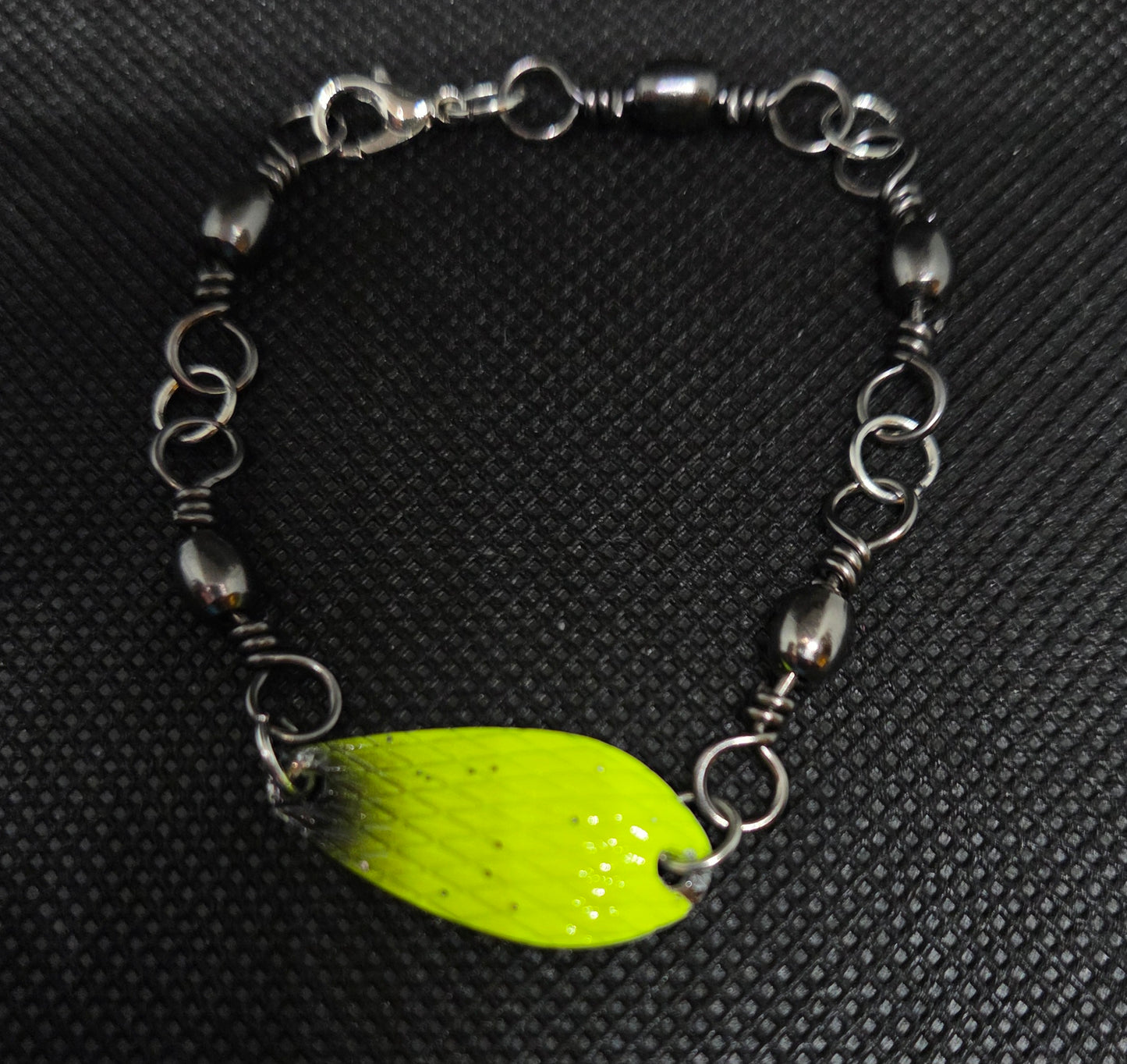 Fishing swivel bracelet with yellow and black spoon lure