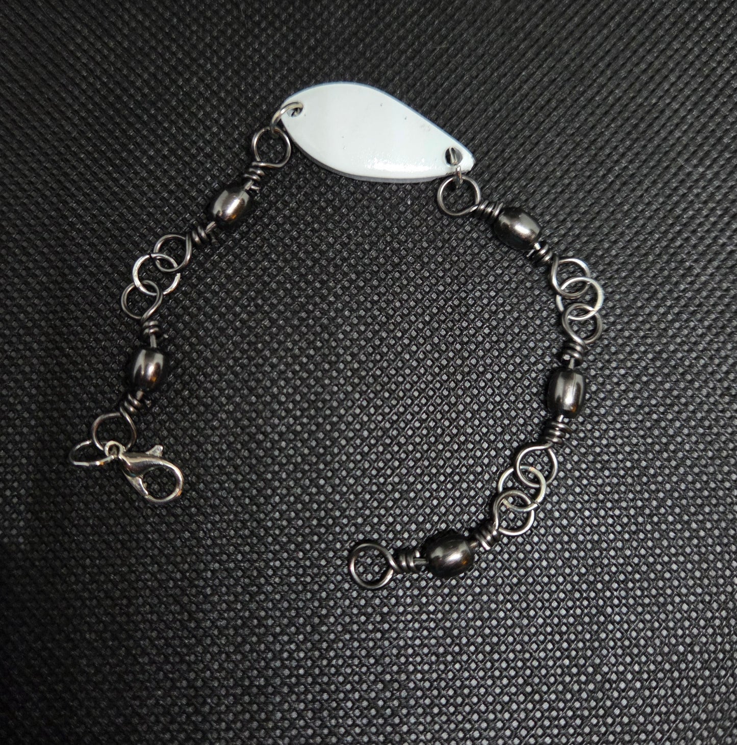 Fishing swivel bracelet with white/glow in the dark spoon lure