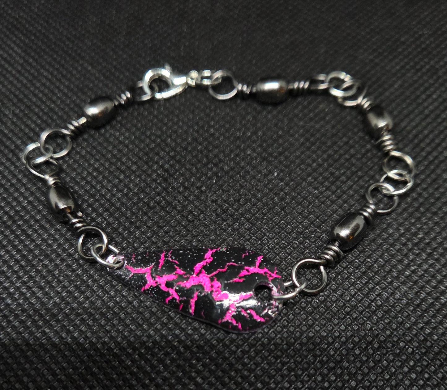 Fishing swivel bracelet with pink and black spoon lure