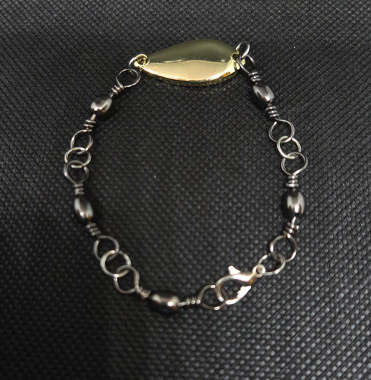 Fishing swivel bracelet with gold spoon lure