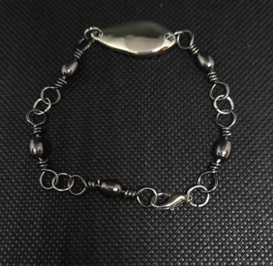 Fishing swivel bracelet with silver spoon lure
