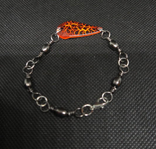 Fishing swivel bracelet with orange and black spoon lure