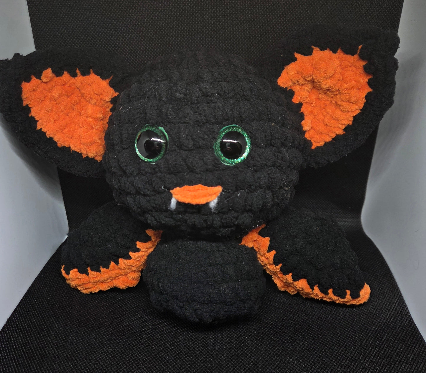 Orange and black bat