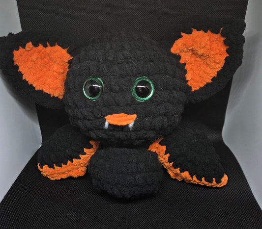 Orange and black bat