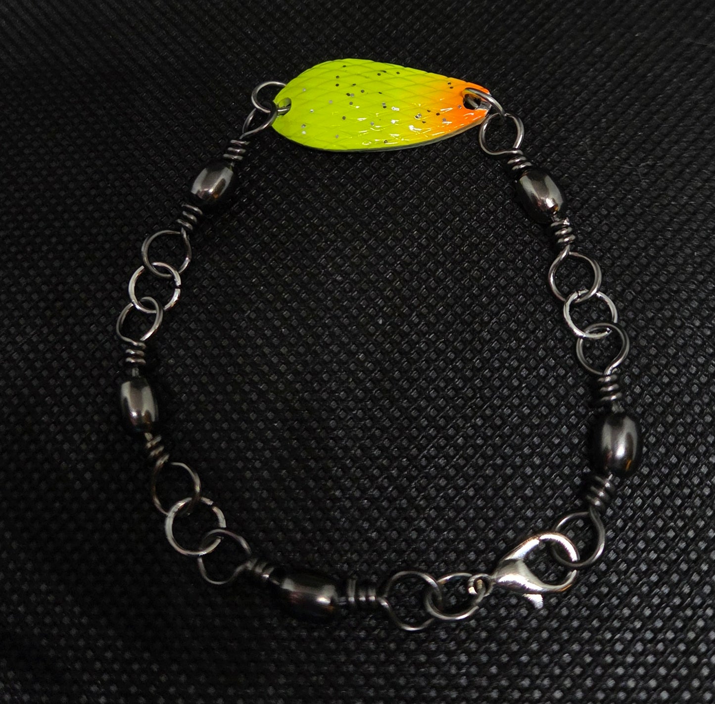 Fishing swivel bracelet with yellow and orange spoon lure
