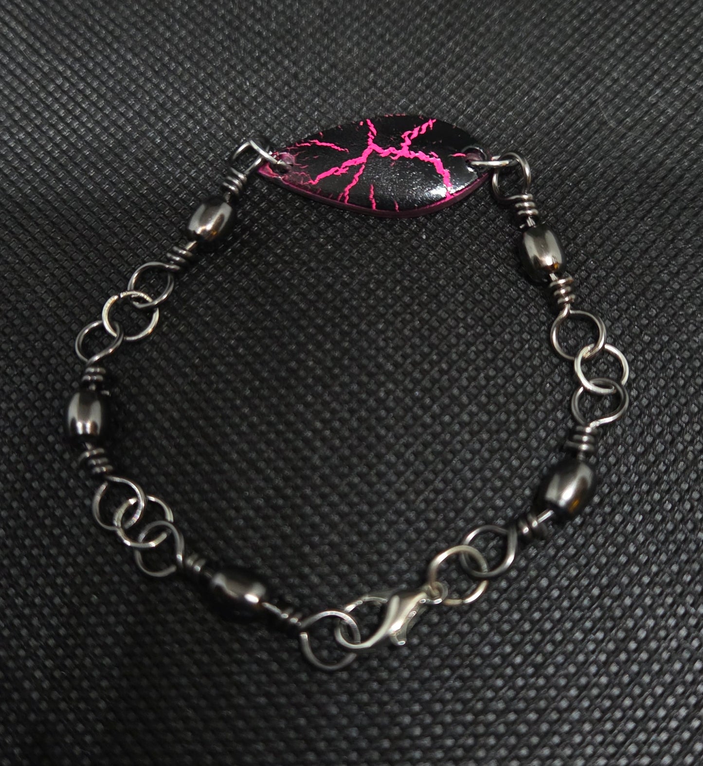 Fishing swivel bracelet with pink and black spoon lure