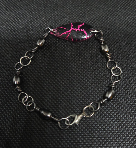Fishing swivel bracelet with pink and black spoon lure